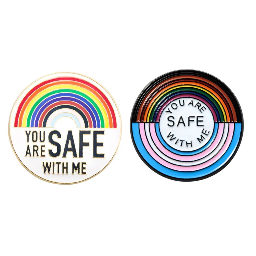 two circular rainbow pride enamel badges with arcs and You are safe with me. Left: rainbow colors; right: rainbow, transgender, and bisexual pride. Enjoy worldwide shipping!.