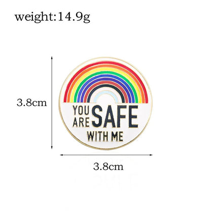 Round rainbow pride enamel badge features YOU ARE SAFE WITH ME below the design, measures 3.8 cm in diameter, weighs 14.9 g, and is available for worldwide shipping.