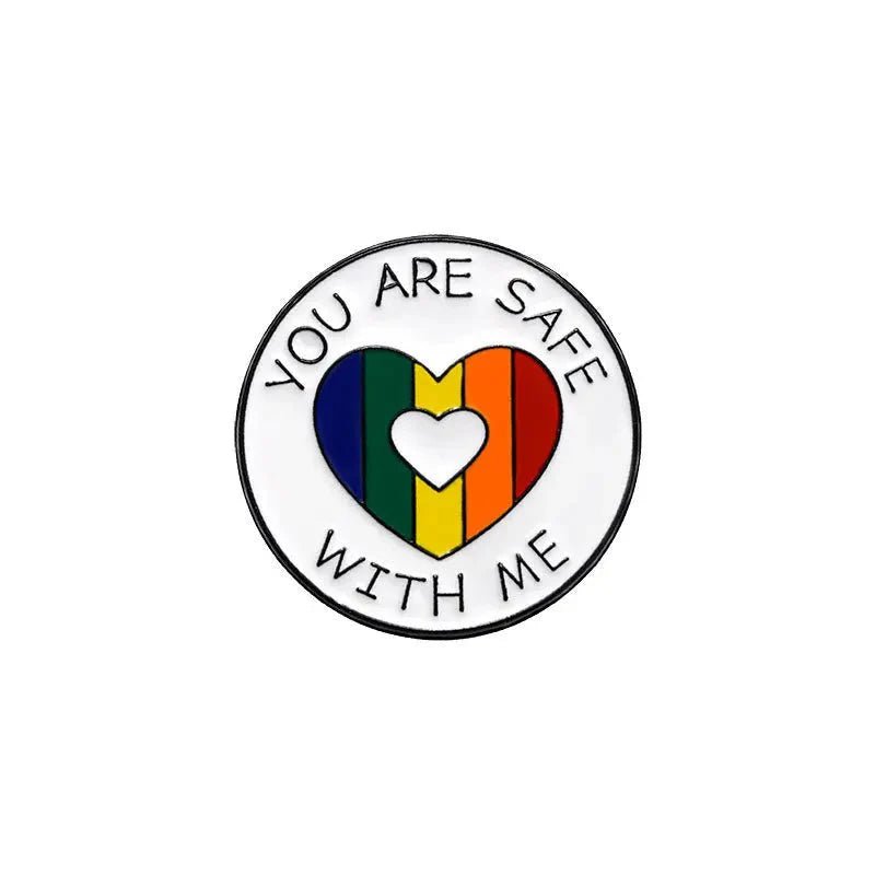 Show your support with the circular pride enamel pin—“YOU ARE SAFE WITH ME” encircles a rainbow-striped heart and a cutout heart adds charm. Love is love. Ships worldwide.